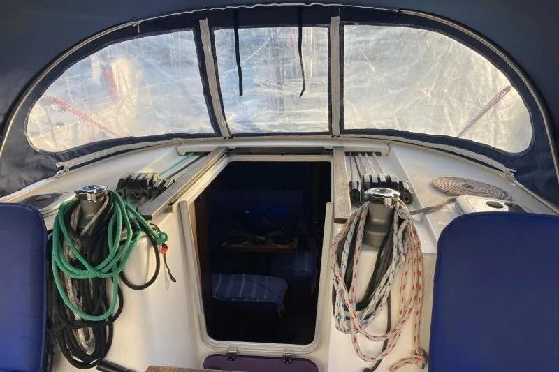 Panopaea Yacht Photos Pics Interior view of 2011 Dufour 405 GL sailboat cockpit with ropes and seating.