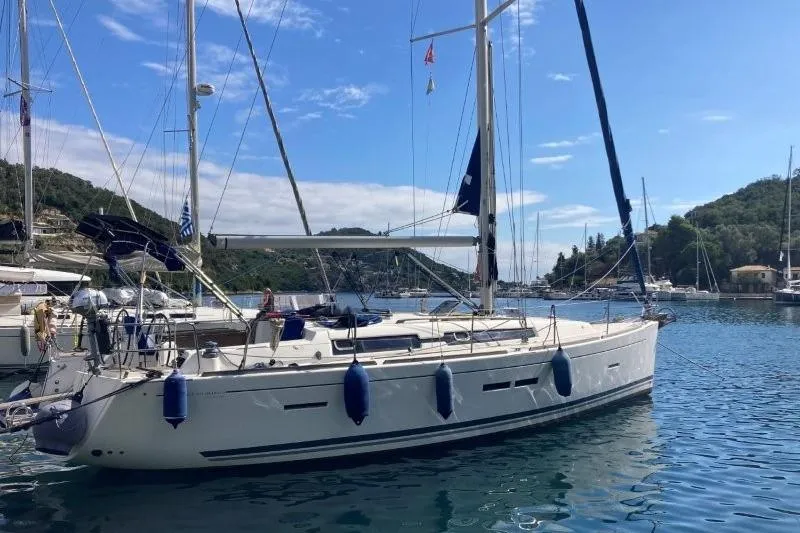 Panopaea Yacht Photos Pics 2011 Dufour 405 GL sailboat docked in a scenic marina.