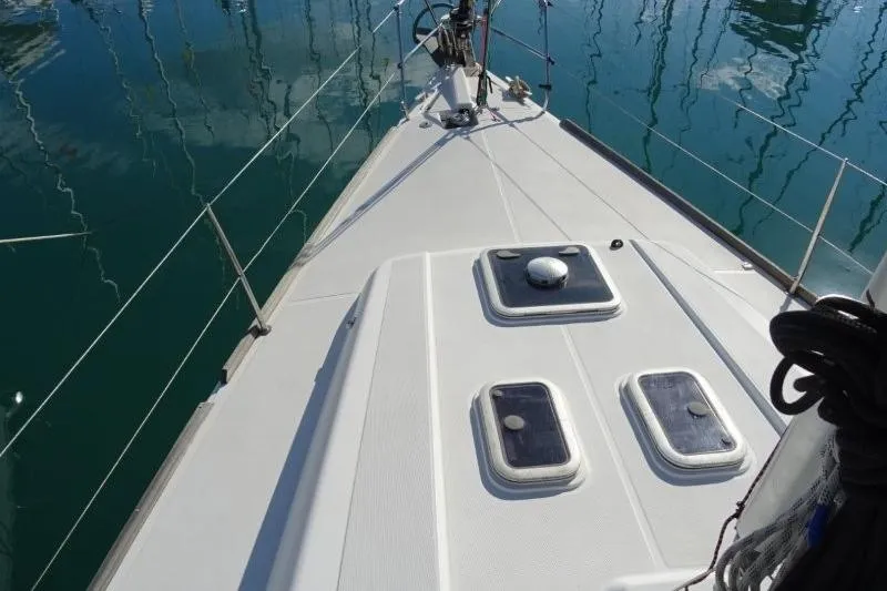 Panopaea Yacht Photos Pics 2011 Dufour 405 GL yacht deck with hatches, docked on calm water.