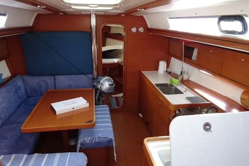 Panopaea Yacht Photos Pics Interior of 2011 Dufour 405 GL yacht with kitchen and seating area.