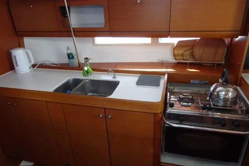 Panopaea Yacht Photos Pics Galley kitchen in 2011 Dufour 405 GL yacht with stove, sink, and kettle.