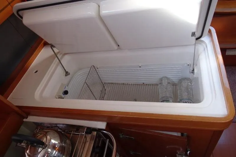 Panopaea Yacht Photos Pics Open refrigerator in 2011 Dufour 405 GL yacht galley with water bottles inside.