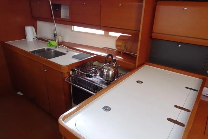 Panopaea Yacht Photos Pics Galley kitchen in 2011 Dufour 405 GL yacht with stove, sink, and storage.