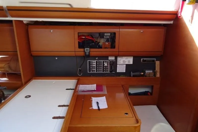 Panopaea Yacht Photos Pics Interior of 2011 Dufour 405 GL yacht with navigation equipment and wooden cabinetry.