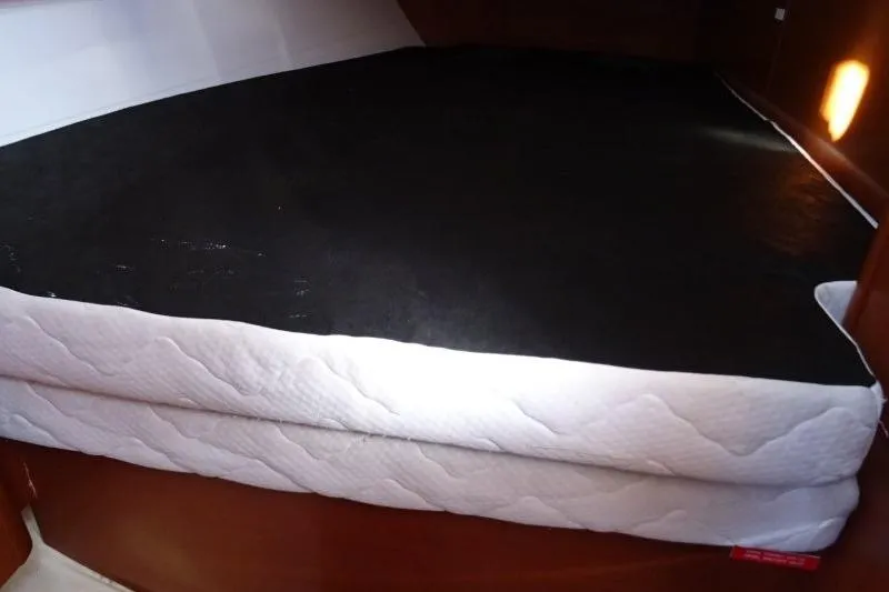 Panopaea Yacht Photos Pics Cabin bed in 2011 Dufour 405 GL yacht, featuring a black mattress cover.