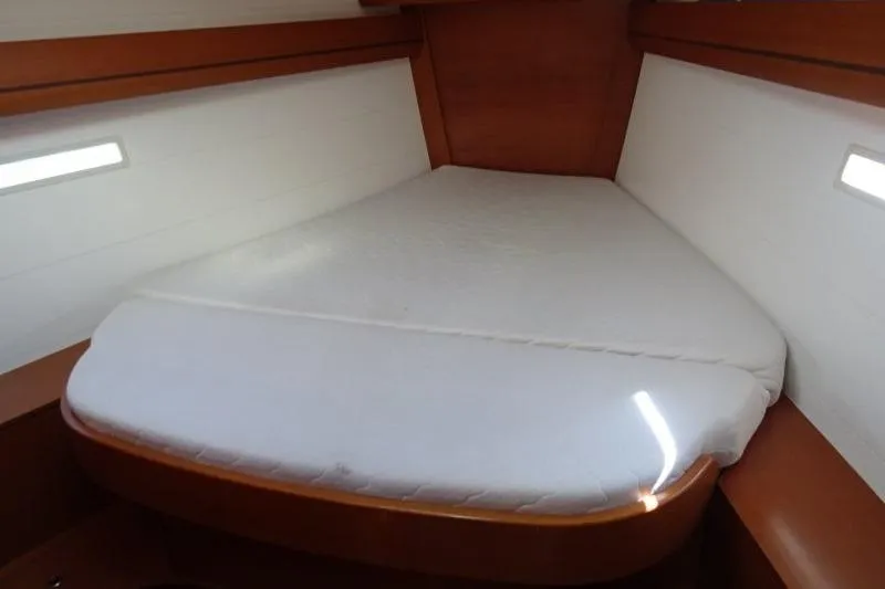 Panopaea Yacht Photos Pics 2011 Dufour 405 GL yacht cabin with a cozy bed and wooden interior.