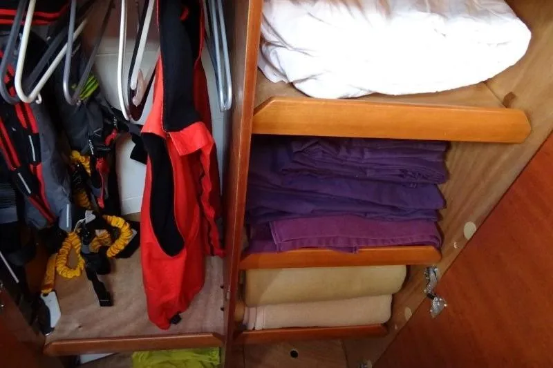 Panopaea Yacht Photos Pics Cabin storage in 2011 Dufour 405 GL yacht with clothes and gear neatly organized.