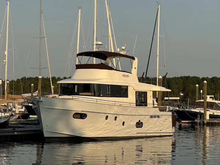 Mischief Yacht Photos Pics 2014 Beneteau Swift Trawler 50 docked at marina, surrounded by sailboats.
