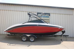 2014 Yamaha Boats 240, red and white, on trailer outside a building.