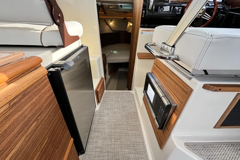  Yacht Photos Pics 2026 Ranger Tugs R-27 interior with modern amenities and cozy cabin space.