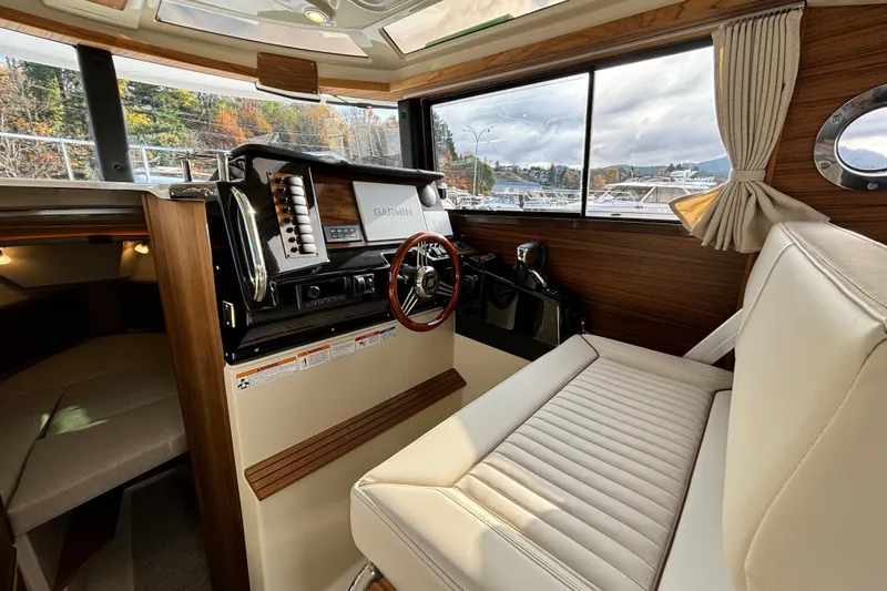  Yacht Photos Pics Interior of 2026 Ranger Tugs R-27 boat with steering wheel and navigation system.