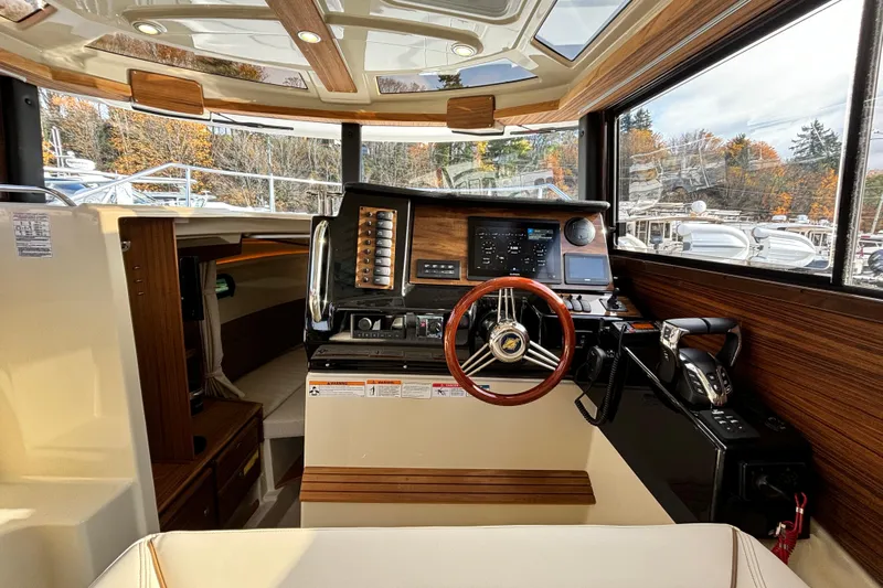  Yacht Photos Pics 2026 Ranger Tugs R-27 boat interior with modern helm and wood accents.