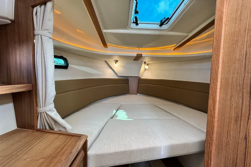  Yacht Photos Pics 2026 Ranger Tugs R-27 interior cabin with skylight and cozy seating.