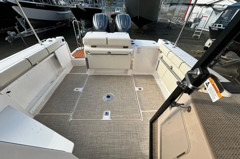  Yacht Photos Pics 2026 Ranger Tugs R-27 boat interior with spacious deck and seating area.