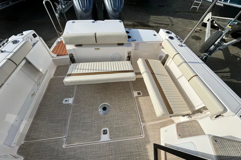  Yacht Photos Pics 2026 Ranger Tugs R-27 boat interior with cushioned seating and spacious deck layout.