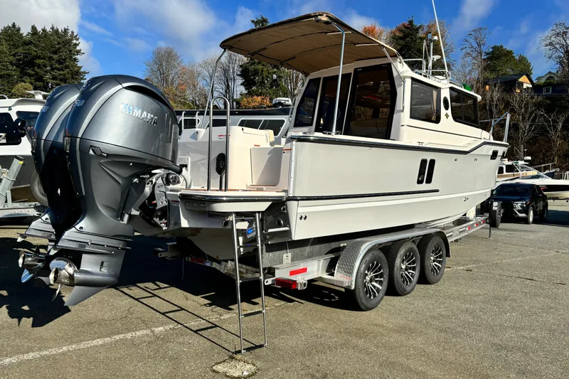  Yacht Photos Pics 2026 Ranger Tugs R-27 boat on trailer with Yamaha outboard engines, parked outdoors.