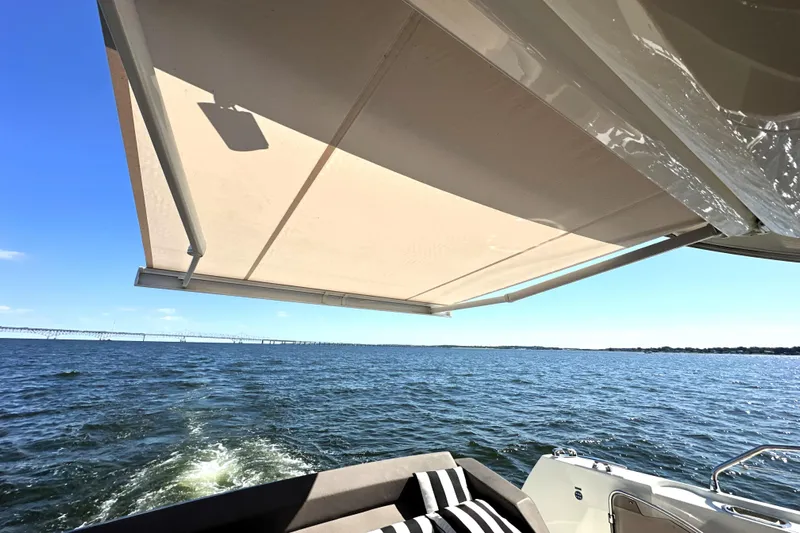 Eribella Yacht Photos Pics 2016 Prestige 500S yacht with awning, cruising on open water under clear blue sky.