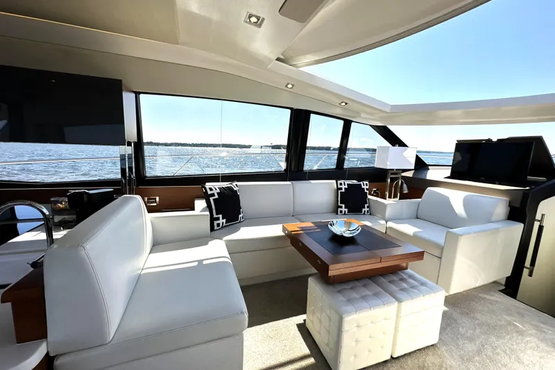 Eribella Yacht Photos Pics Luxurious interior of a 2016 Prestige 500S yacht with elegant seating and panoramic windows.