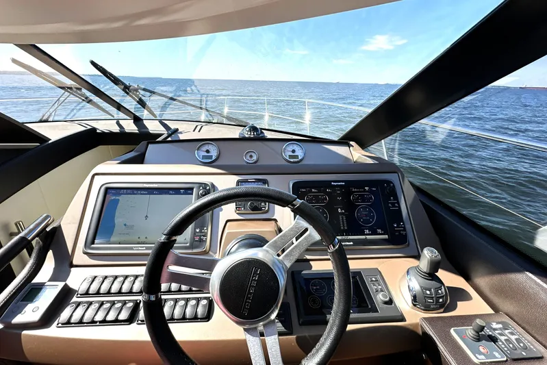 Eribella Yacht Photos Pics Cockpit view of 2016 Prestige 500S yacht with navigation screens and steering wheel.