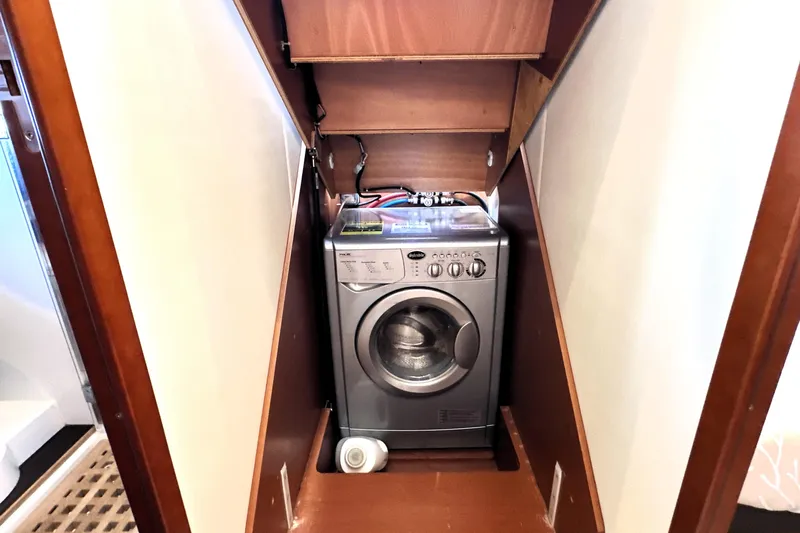 Eribella Yacht Photos Pics Compact washing machine in a 2016 Prestige 500S yacht's wooden compartment.