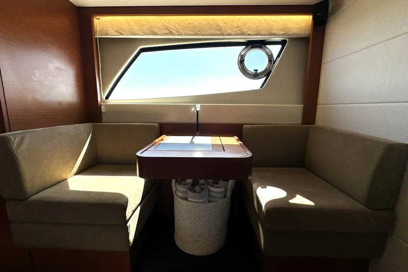 Eribella Yacht Photos Pics Luxurious interior of 2016 Prestige 500S yacht with cozy seating and elegant window view.