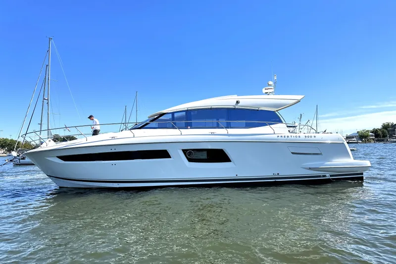 Eribella Yacht Photos Pics 2016 Prestige 500S yacht on calm water under clear blue sky.