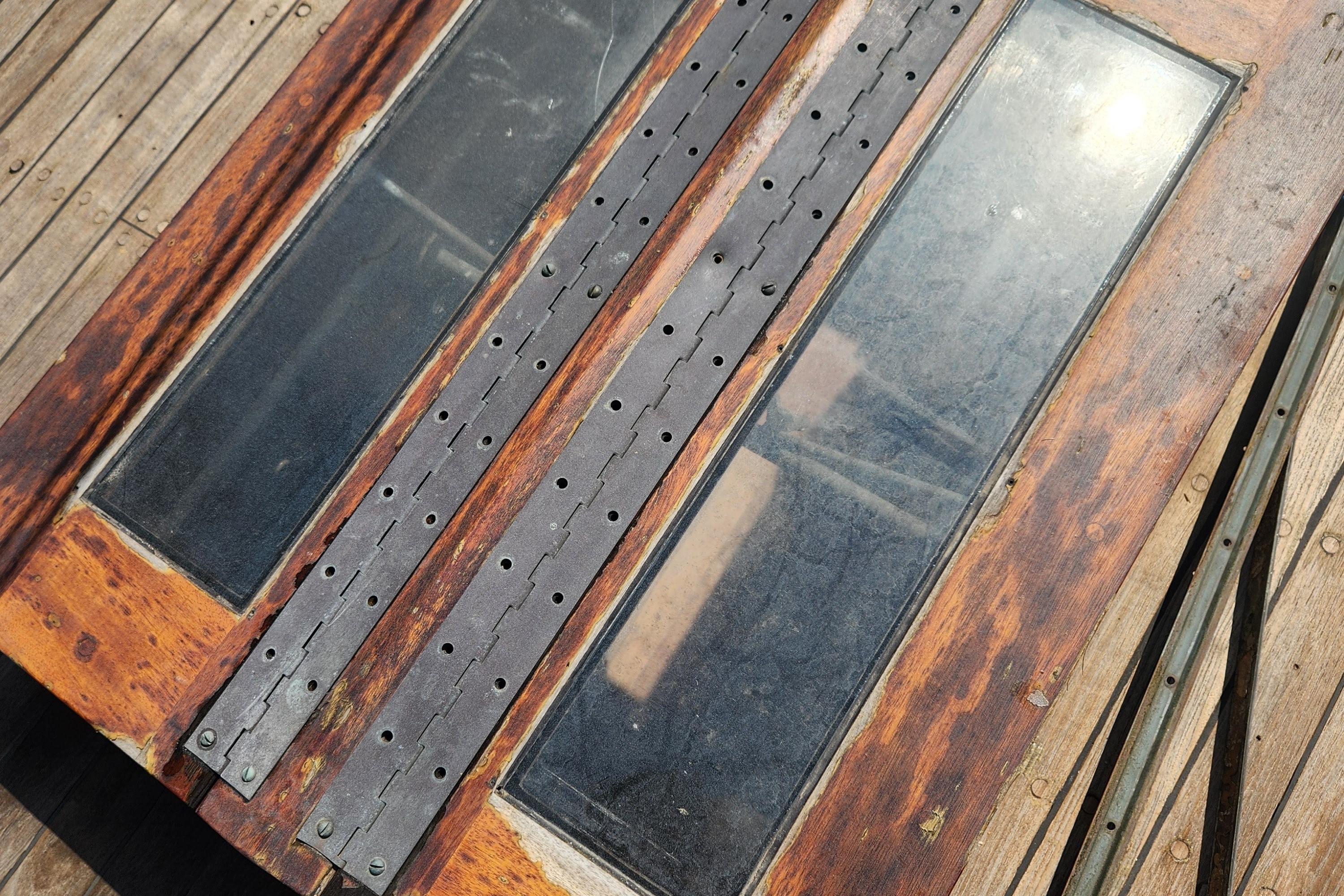 Close-up of 1959 Geerd Hendel Raised-Deck Cutter's wooden deck with metal hinges.