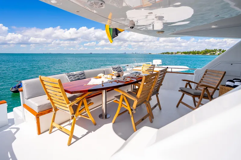 Azure Yacht Photos Pics Luxurious 1991 Maiora flybridge yacht with elegant outdoor dining area overlooking the ocean.