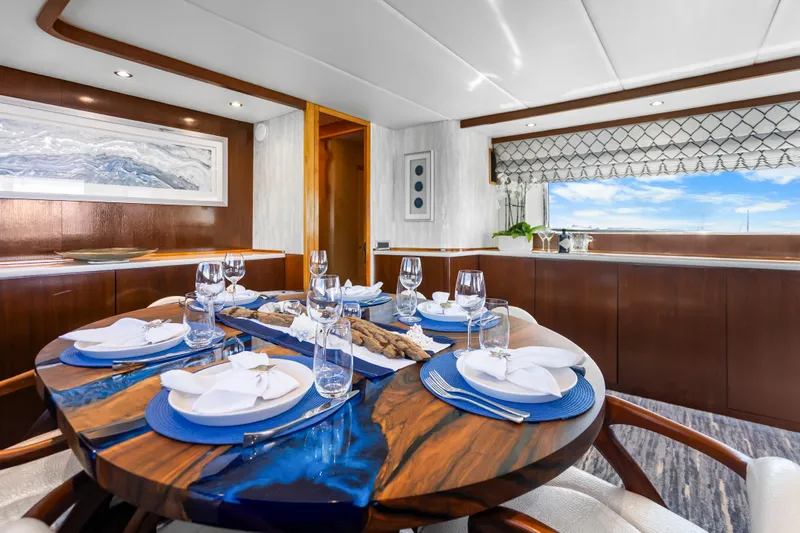 Azure Yacht Photos Pics Luxurious dining area on a 1991 Maiora flybridge yacht, featuring elegant table settings.