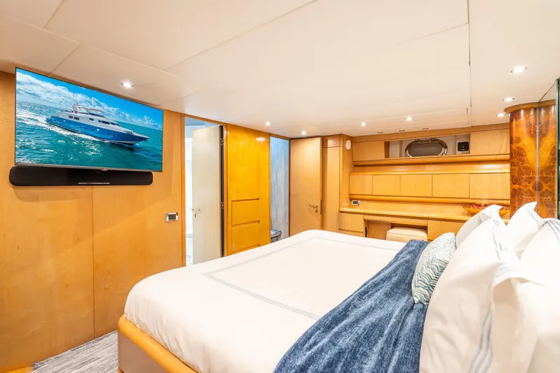 Azure Yacht Photos Pics Luxurious 1991 Maiora flybridge yacht bedroom with modern decor and wall-mounted TV.