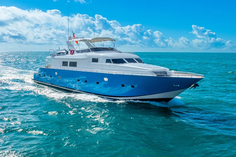 Azure Yacht Photos Pics Luxurious 1991 Maiora flybridge yacht cruising on clear blue ocean waters.