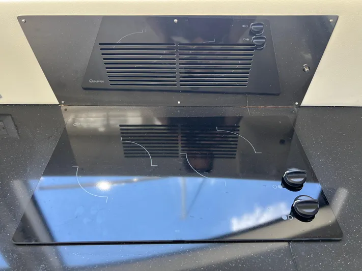 Melody Rose Yacht Photos Pics Stovetop on 2016 Carver C34 Command Bridge yacht, featuring sleek black design and control knobs.