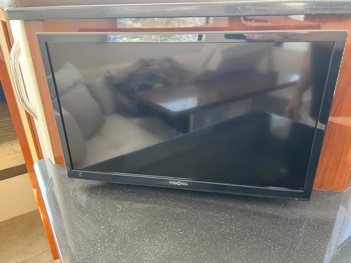 Melody Rose Yacht Photos Pics Insignia TV on black countertop inside 2016 Carver C34 Command Bridge yacht.