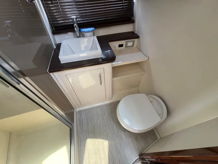 Melody Rose Yacht Photos Pics Bathroom interior of 2016 Carver C34 Command Bridge yacht, featuring sink and toilet.