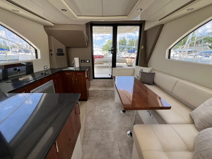 Melody Rose Yacht Photos Pics Luxurious interior of 2016 Carver C34 Command Bridge yacht with modern kitchen and seating area.