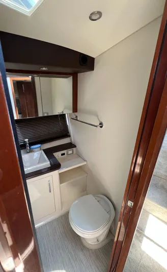 Melody Rose Yacht Photos Pics Bathroom interior of 2016 Carver C34 Command Bridge yacht, featuring sink and toilet.