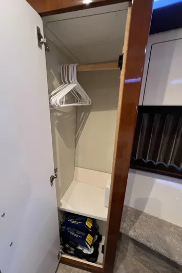 Melody Rose Yacht Photos Pics Closet interior on 2016 Carver C34 Command Bridge with hangers and storage space.