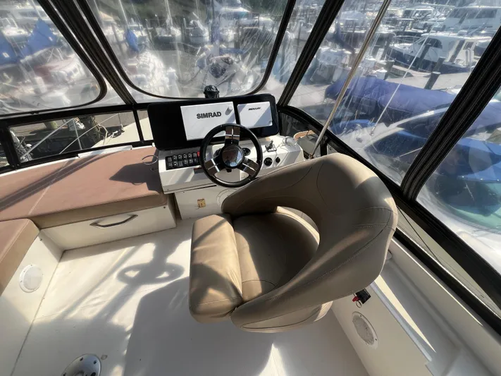 Melody Rose Yacht Photos Pics Interior of 2016 Carver C34 Command Bridge with steering wheel and navigation system.
