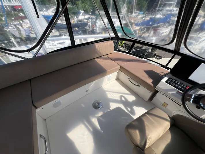 Melody Rose Yacht Photos Pics Interior of 2016 Carver C34 Command Bridge with seating and helm, overlooking marina.