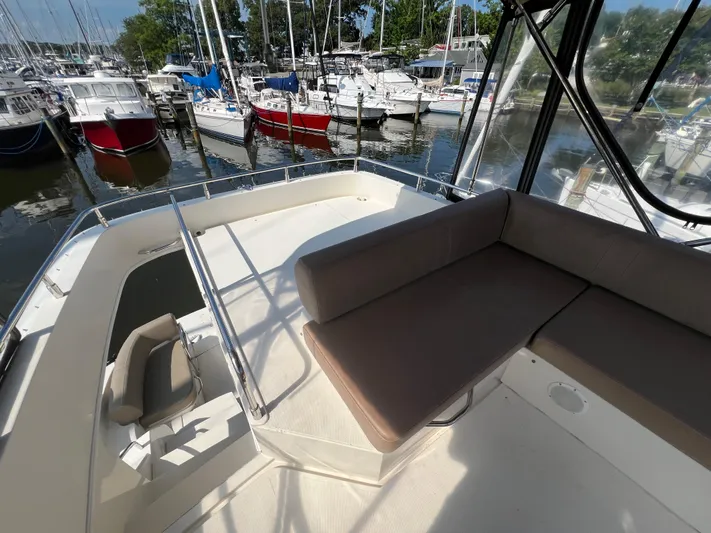 Melody Rose Yacht Photos Pics 2016 Carver C34 Command Bridge with seating area, docked among other boats.