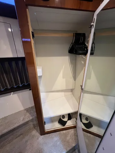 Melody Rose Yacht Photos Pics Interior closet of 2016 Carver C34 Command Bridge yacht with hangers and mirror.