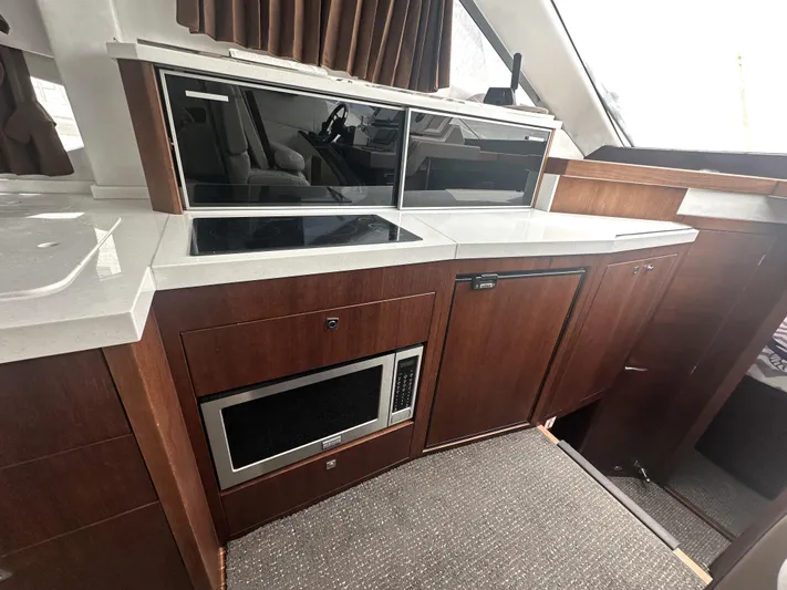Knot Guilty Yacht Photos Pics Modern kitchen interior of 2016 Galeon 380 Fly yacht with sleek cabinetry and appliances.