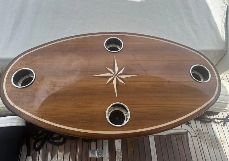 Knot Guilty Yacht Photos Pics Wooden table with star design and cup holders on Galeon 380 Fly, 2016 model.
