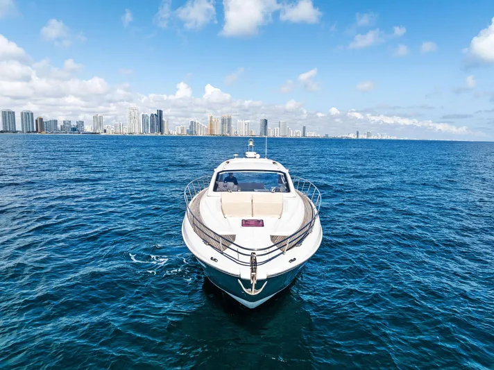 Manik Yacht Photos Pics Azimut Atlantis 50 yacht cruising on ocean with city skyline in background, 2016 model.