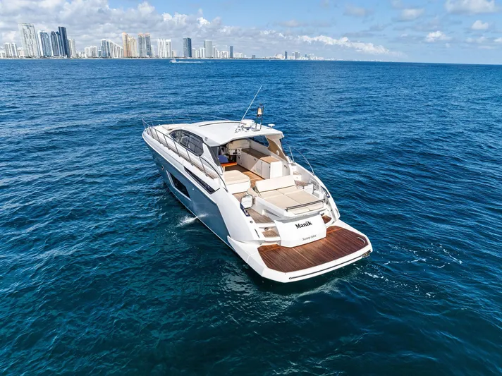 Manik Yacht Photos Pics Azimut Atlantis 50 yacht cruising near city skyline, 2016 model, on a sunny day.