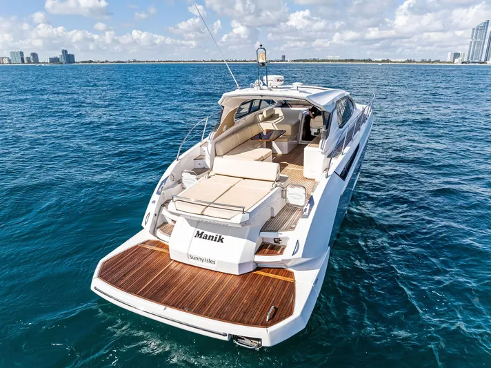 Manik Yacht Photos Pics Azimut Atlantis 50 yacht, 2016 model, cruising on open water with city skyline in background.