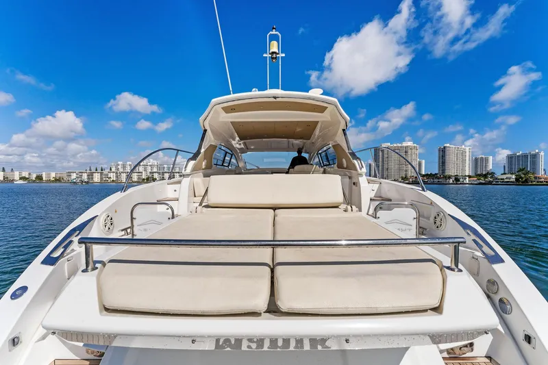 Manik Yacht Photos Pics Azimut Atlantis 50 yacht, 2016 model, docked with city skyline and blue sky background.