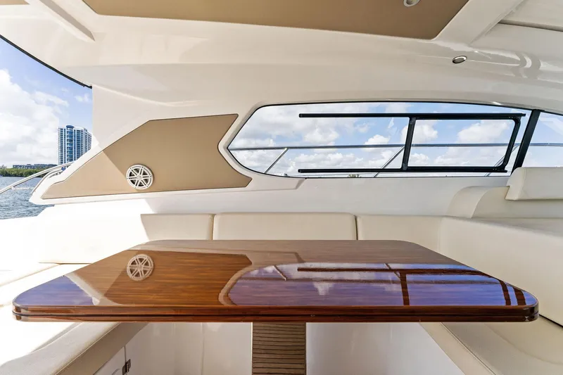 Manik Yacht Photos Pics Azimut Atlantis 50 yacht interior, 2016 model, featuring elegant wood table and plush seating.