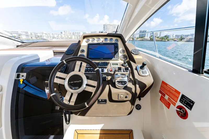 Manik Yacht Photos Pics Cockpit of 2016 Azimut Atlantis 50 yacht with steering wheel and control panel.