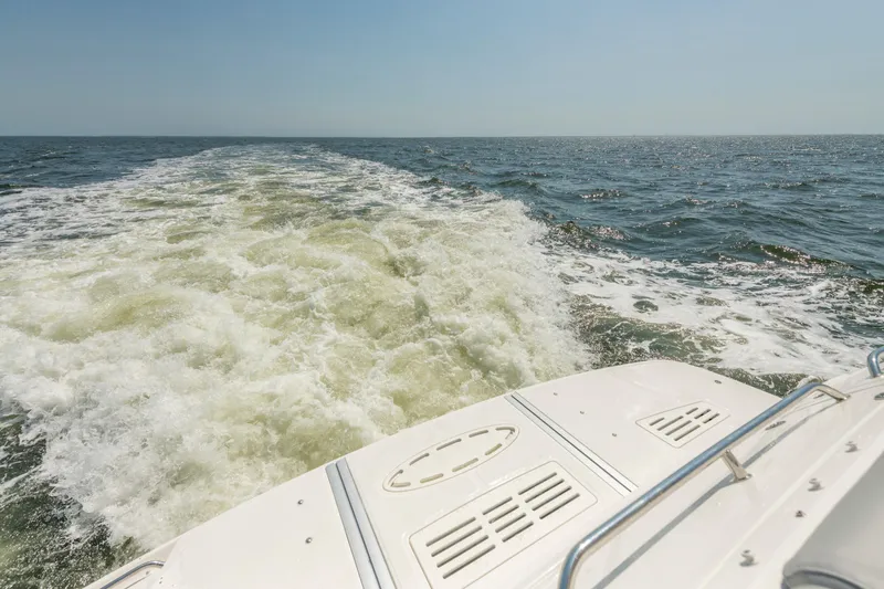  Yacht Photos Pics 2017 Sea Ray Fly 510 cruising, leaving a wake on open water.